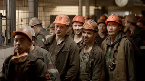 BBC/DAVY MCILVEEN Coal miners prepare to work along 16km of tunnels in eastern Ukraine