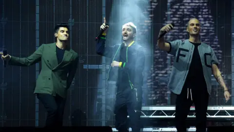 Anthony Devlin Tom Parker on stage with his bandmates in November 2021