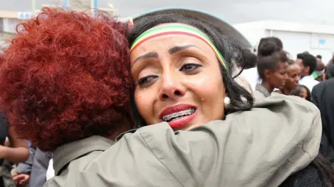 Reuters Relatives embrace after meeting at Asmara International Airport, after one arrived aboard the Ethiopian Airlines ET314 flight in Asmara, Eritrea July 18, 2018.