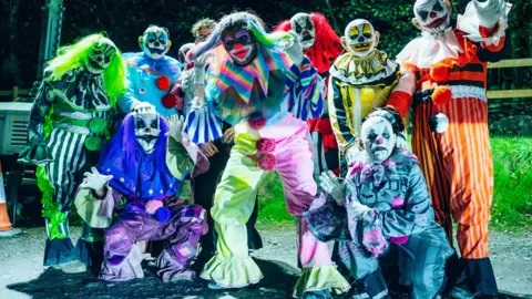 Ffear Fforest - Zip World Scary clowns in multi-coloured outfits and wigs