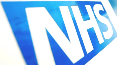 Getty Images A stock photo of the NHS logo, which consists of white letters on a blue background.
