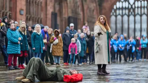 Talking Birds/ Andrew Moore The actors Richard Colvin (left) and Amy Kakoura perform It Takes a City by Talking Birds, in the ruins of Coventry cathedral.