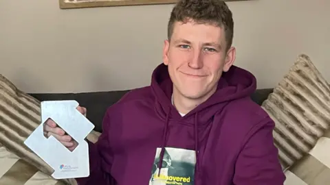 Official Charts Company Nathan Evans with his official number one trophy