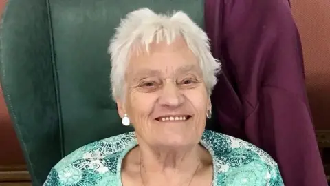 Robert Golledge Mary Golledge sitting in a chair