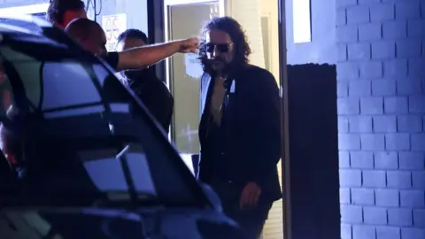 Reuters British comedian and actor Russell Brand walks outside the Wembley Park Theatre, in northwest London