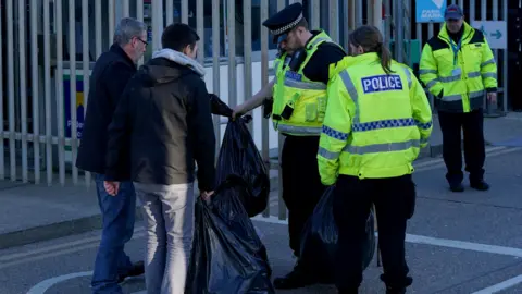 PA Media Former P&O workers collect their belongings after being fired