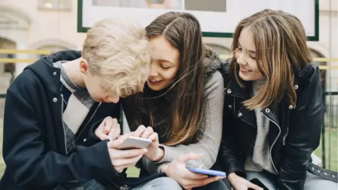 Getty Images Teenagers using smartphones