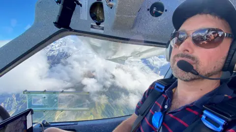 V1 Flight Hal Colliver at the controls of a light aircraft in flight