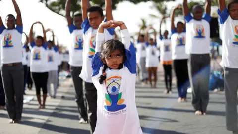 Reuters A young girl performs yoga exercises in Durban, South Africa