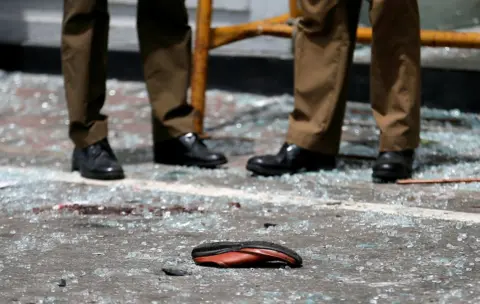 Dinuka Liyanawatte/REUTERS A shoe of a victim is seen on the floor after an explosion in the city of Colombo, Sri Lanka.