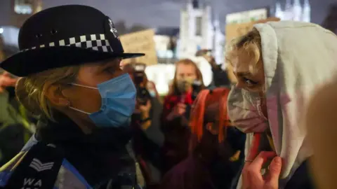 Reuters A police woman with a protester