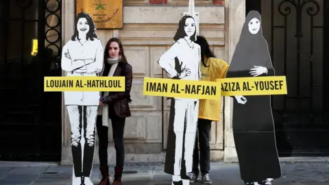 Reuters Amnesty International urges Saudi authorities to release activists Loujain al-Hathloul, Eman al-Nafjan and Aziza al-Yousef, outside the Saudi Arabian embassy in Paris, March 8, 2019