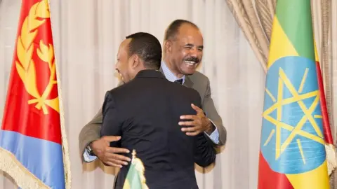 GHIDEON MUSA ARON VISAFRIC/Reuters Ethiopia's Prime Minister Abiy Ahmed (L) and Eritrean President Isaias Afwerki (R) hugging in Asmara, Eritrea - Monday 9 July 2018