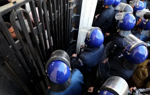 EPA Algerian policemen block a march of Algerian students protesting against a potential fifth term for President Abdelaziz Bouteflika in Algiers, Algeria, 26 February 2019