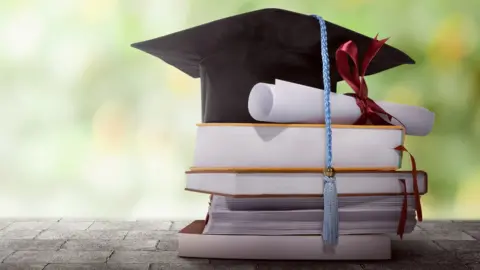 Getty Images File photo of books and mortarboard