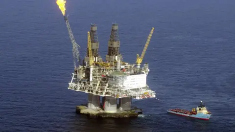 Getty Images A flame burns off excess gas fumes on the top of the five-billion dollar drilling platform Hybernia off the coast of Newfoundland April 21, 2003 in the north Atlantic Ocean