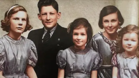 Family Handout A colour portrait of Alan McQuillin with his sisters