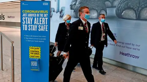 AFP  British Airways pilots wearing masks walk through Heathrow Airport