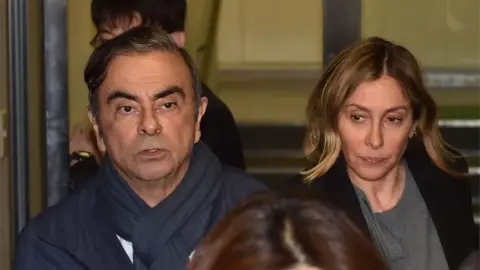 AFP/Getty Images Carlos and Carole Ghosn