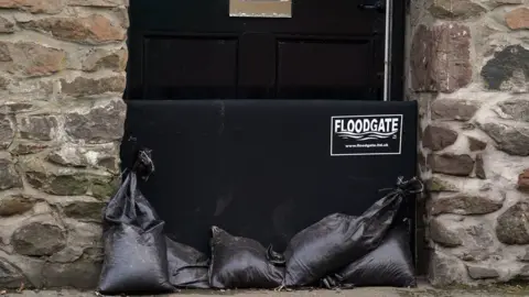 Andrew Milligan/PA Wire Floodgate on door of house in Scotland