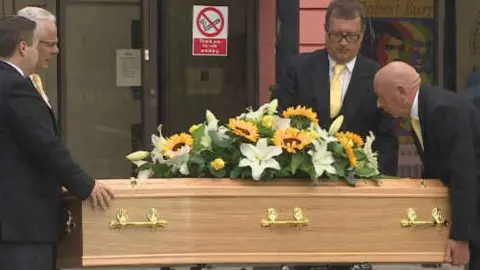 Undertakers prepare to move the coffin of Emma Faulds