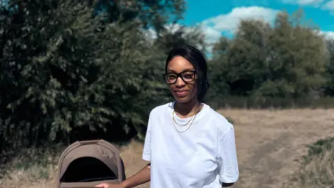 Natasha, wearing a white top and glasses