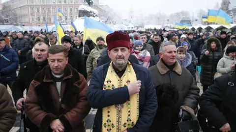 Reuters Ukrainians gather outside Saint Sophia's Cathedral in Kiev