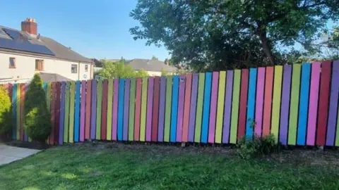 Family photo Brightly-coloured fence