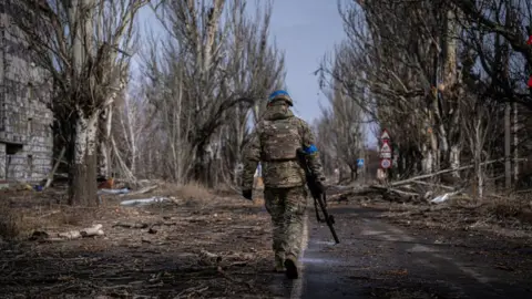 Getty Images A soldier walks through Bakhmut