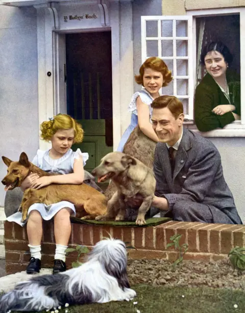 Getty Images Elizabeth and Margaret with their parents and dogs at Windsor in 1936