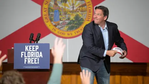 Getty Images DeSantis about to throw a literal hat