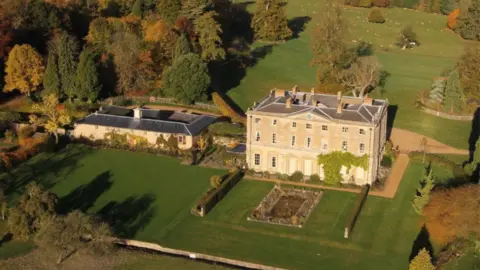 Courteenhall Estate Three-storey Northamptonshire stone stately home with formal garden in front and parkland behind