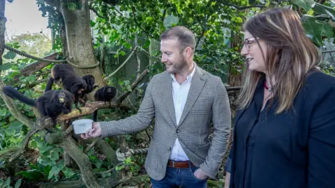 Blue Islands Rob Veron with Dr Lesley Dickie looking at Black Lion Tamarins