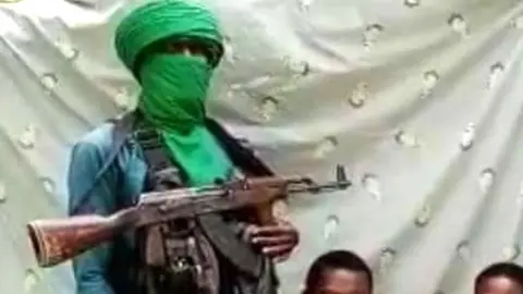 Daily Trust A gunmen posing with train hostages