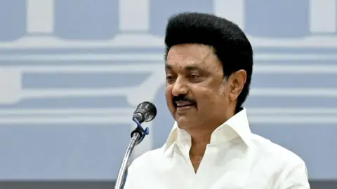 Getty Images MK Stalin, the chief minister of India's Tamil Nadu state, addressing a rally in 2020, seen wearing a white shirt and standing in front of a mic.