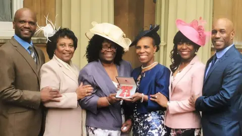 Linette Haines Linette Haines with her family when she received her MBE