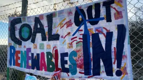 Protest signs at the proposed site of the new Cumbria coal mine