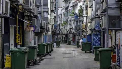 Getty Images Alley Singapore green recycling bins