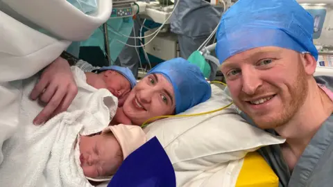 Family photo Bethan Dyke, her husband Craig and their twins in hospital