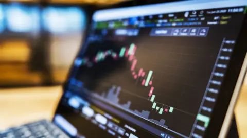 Getty Images/Thana Prasongsin Stock market data on laptop