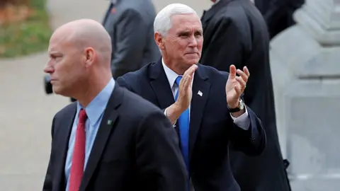 Reuters U.S. Vice President Mike Pence reacts to supporters outside the New Hampshire State House as he walks near his Chief of Staff Marc Short
