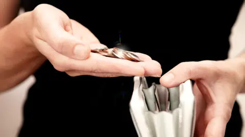 Getty Images Cash in purse