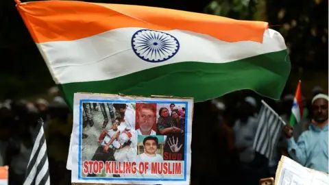 AFP Activists and supporters of the Jamiat Ulama-i-Hind, an Indian Islamic ogranisation, hold India's national flags and placards as they take part in a 'Peace March' protest rally in New Delhi on August 13, 2017
