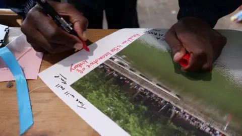 Colin Moody A person signs the picture of the Colston statue being pushed into the harbour