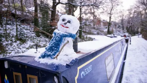 Getty Images A snowman sits a canal boat in Llangollen