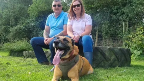 PACT Mike Palmer with his wife Debbie and new addition Chase the dog