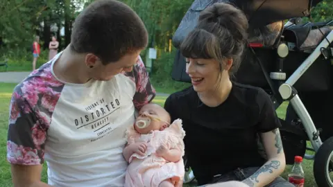 Watson family Chloe (left), baby Thea, and Thea's dad