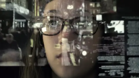 Getty Images An Asian woman concentrating on a touch screen display