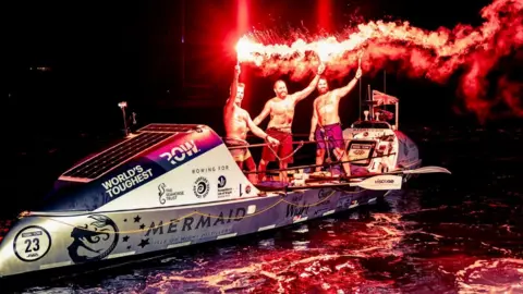 @toughestrow Team Mermaid Atlantic standing on their boat