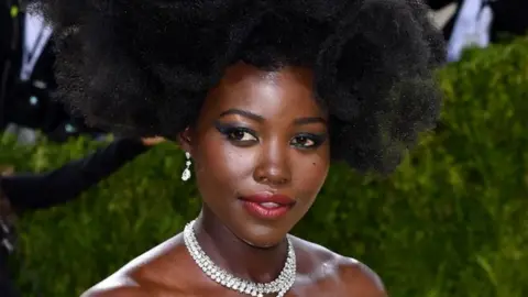 Lupita Nyong'o poses on the red carpet.